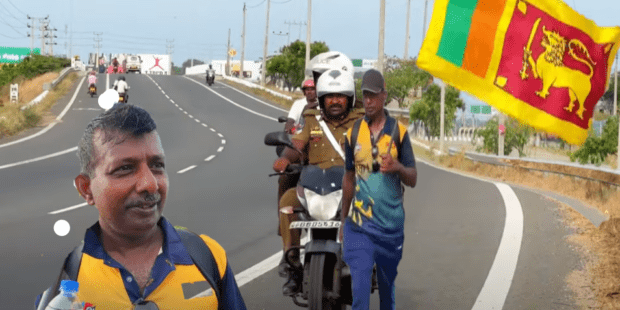 சிங்ககொடியுடன் நடப்பவருக்கு பொலிஸ் பாதுகாப்பு